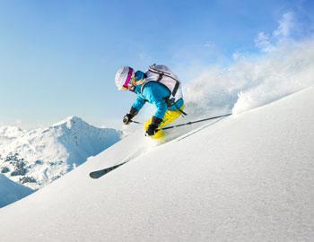 Skiier going downhill in Mammoth Lakes, CA