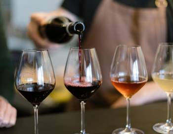 Vendor pouring wine into a glass