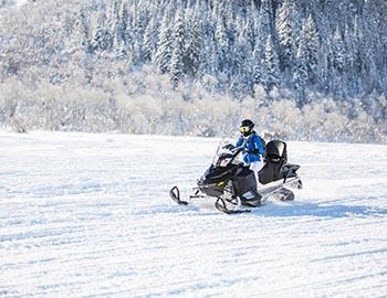 Guy enjoying a snowmobile ride in Mammoth