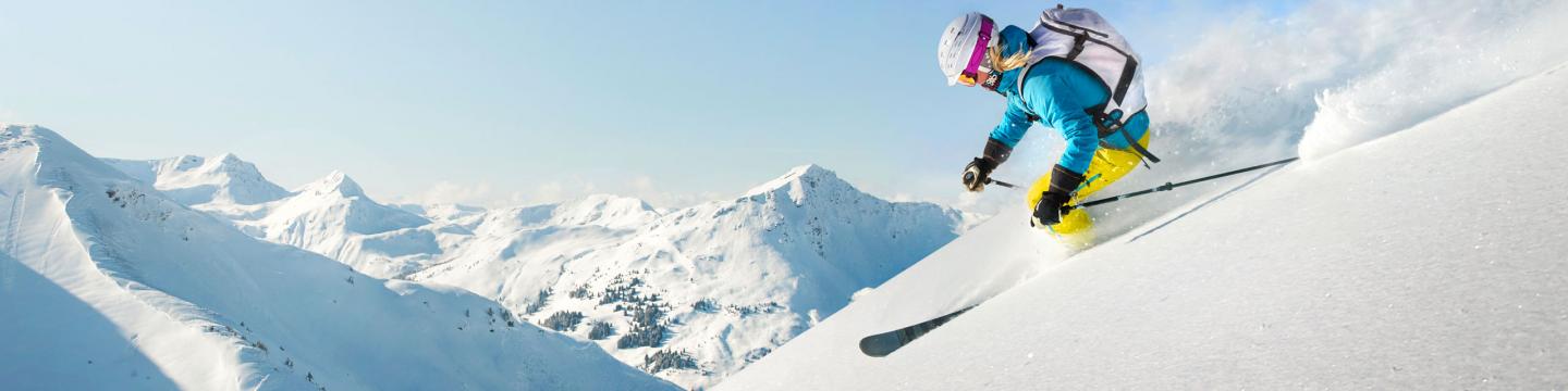 Skiier going down a mountain in Mammoth Lakes, CA