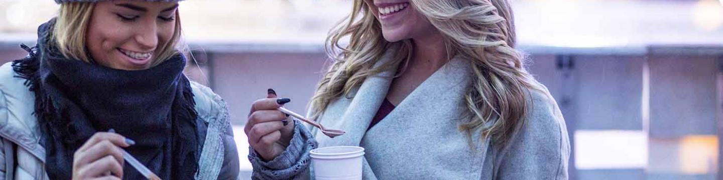 Two friends enjoying hot cocoa in Mammoth Lakes together