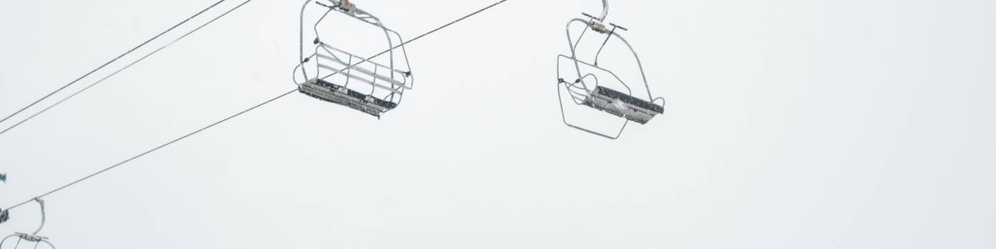 Man sitting under ski lift