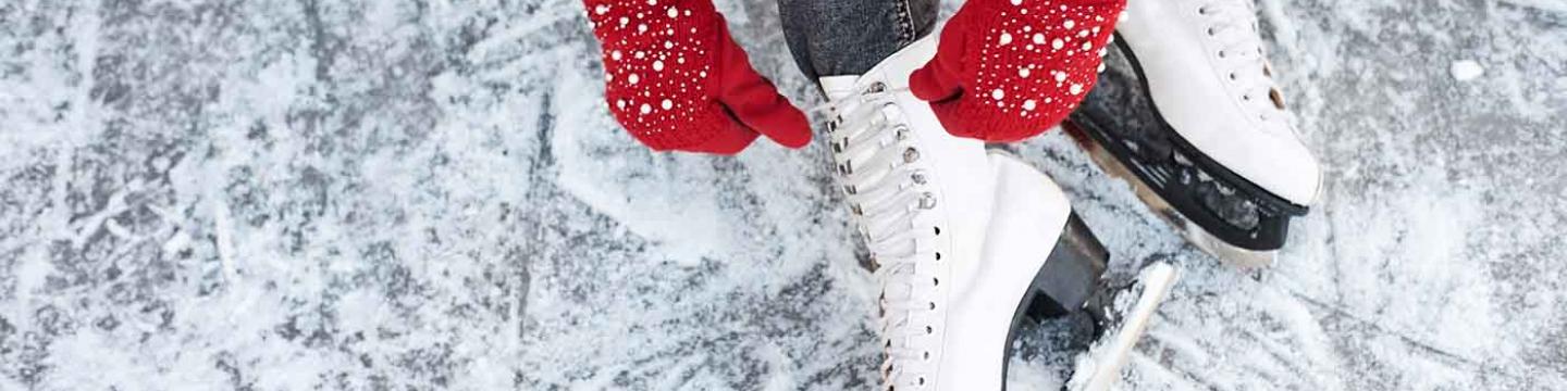 Young girl putting on ice skates in Mammoth Lakes, CA