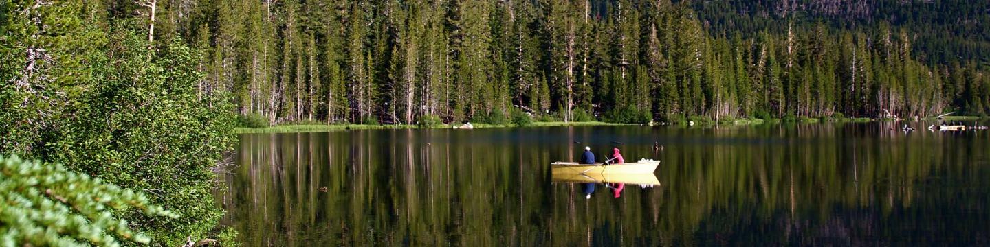 Couple kayaking outside on the water near Mammoth Lakes