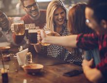 Friends enjoying drinks together at a Happy hour