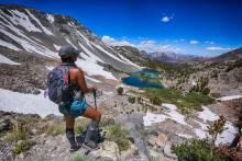 Woman looks out over hiking trail