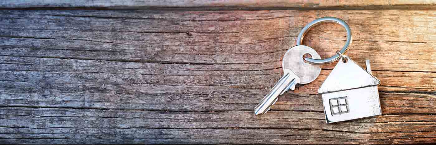 Mammoth condo keys on a wooden table with a house shaped keychain