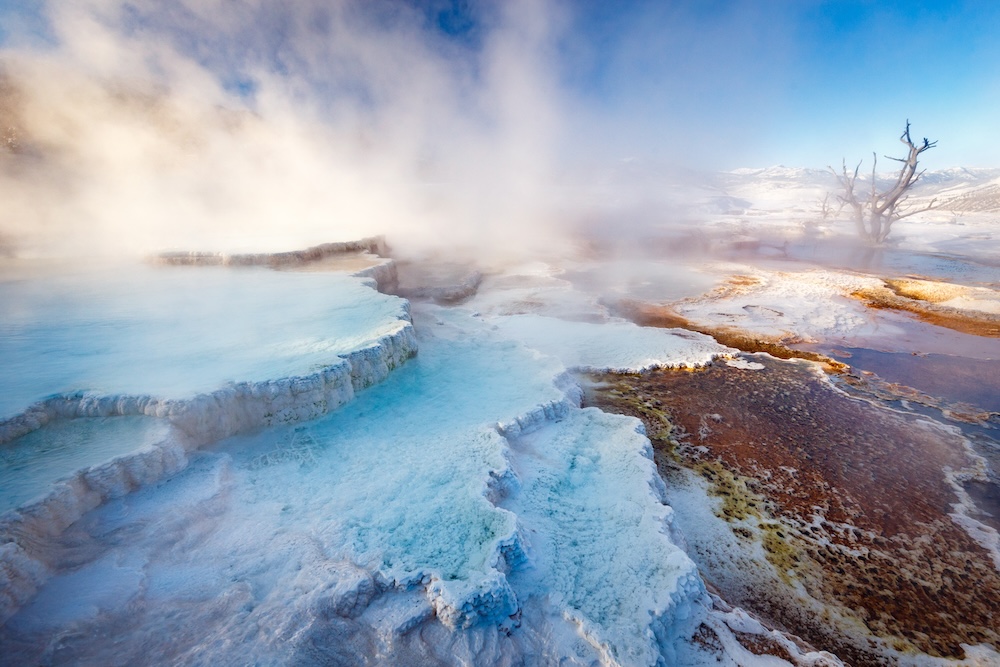 Mammoth Hot Springs with steamy terraces during winter snowy season.