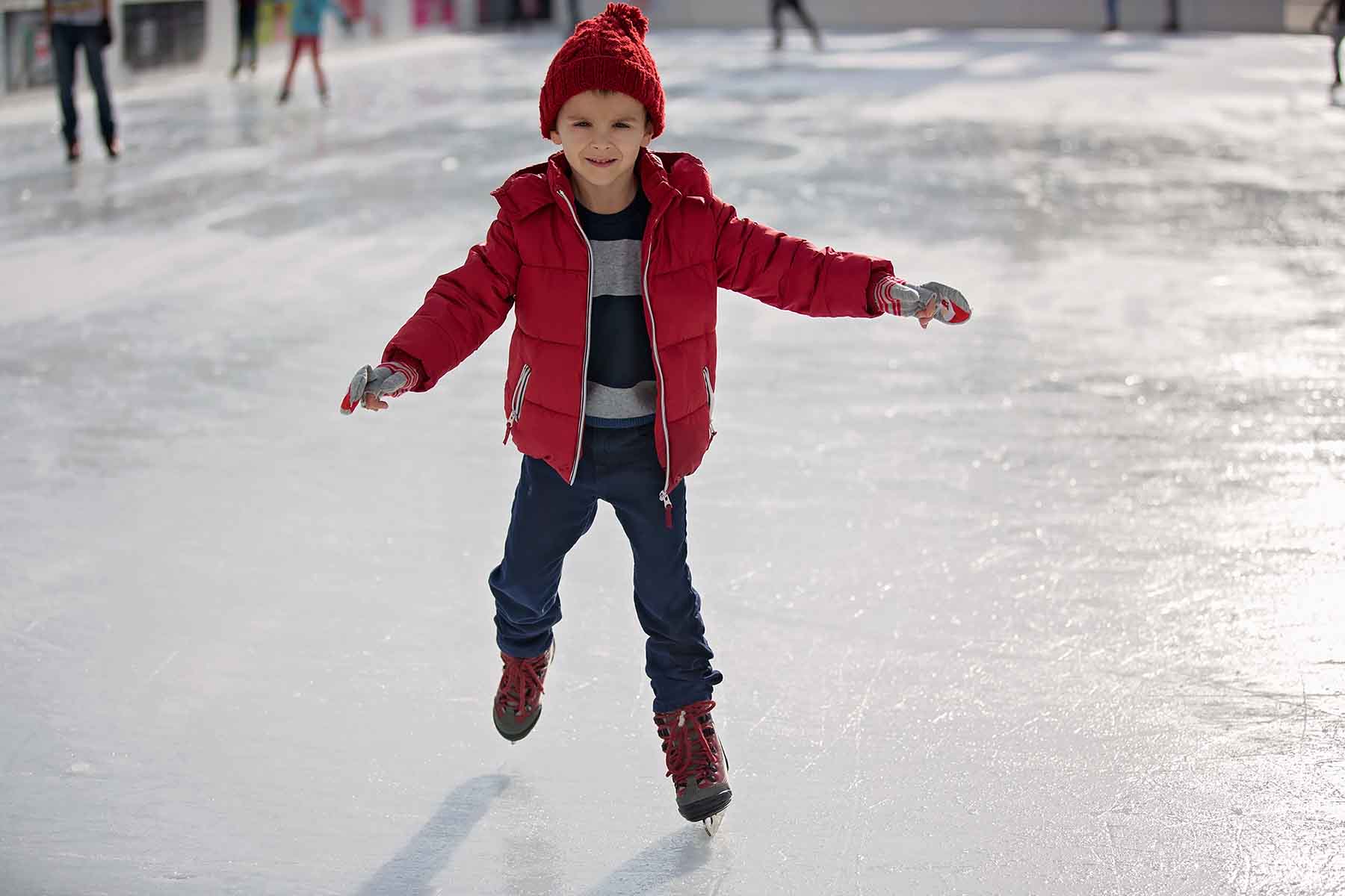 Young boy ice skating at the Mammoth Lakes skate rink
