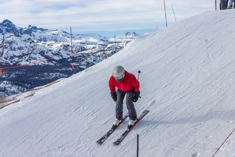 Skier going downhill during snowy landscape.