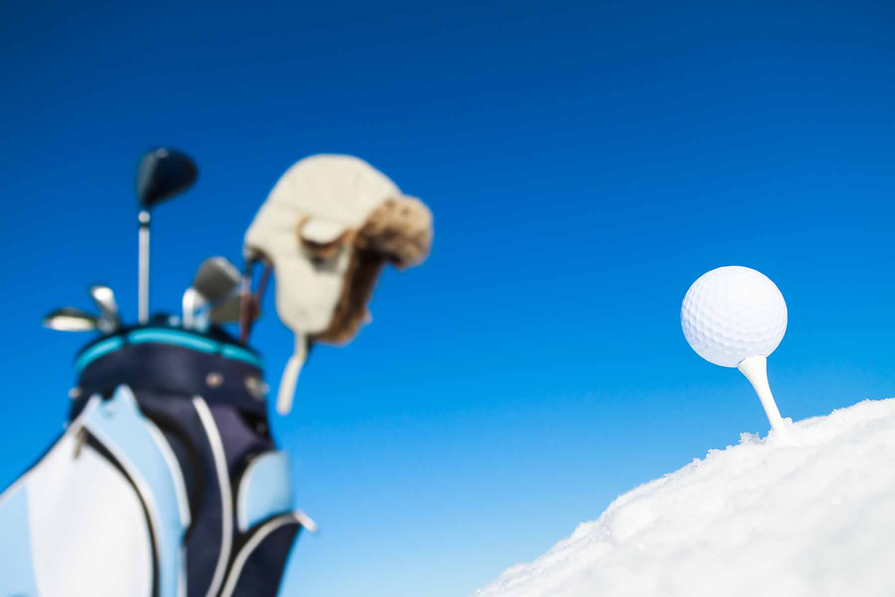 Golf clubs and a golf ball in the winter